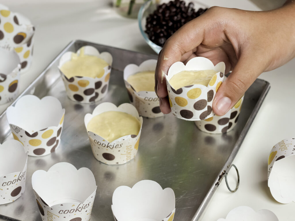 Recyclable Muffin Cups That Deliver Uniform Quality Every Time making vanilla muffin with choco chips top