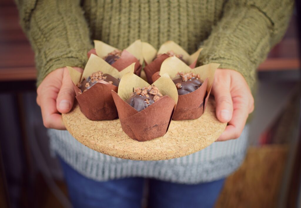 Why Recyclable Muffin Cups Are Ideal For Large Batch Baking midsection woman holding ice cream