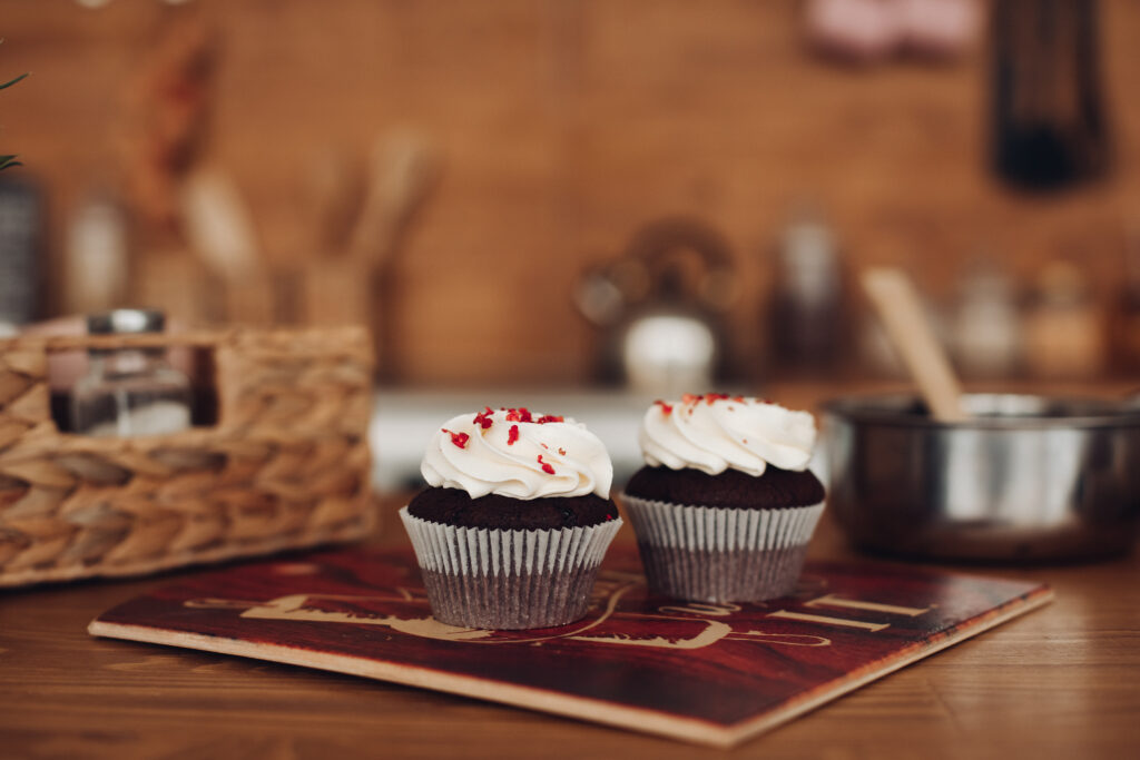 Food Grade Paper Muffin Cups Designed for Busy Professional Kitchens two yummy chocolate cupcackes with a white cream